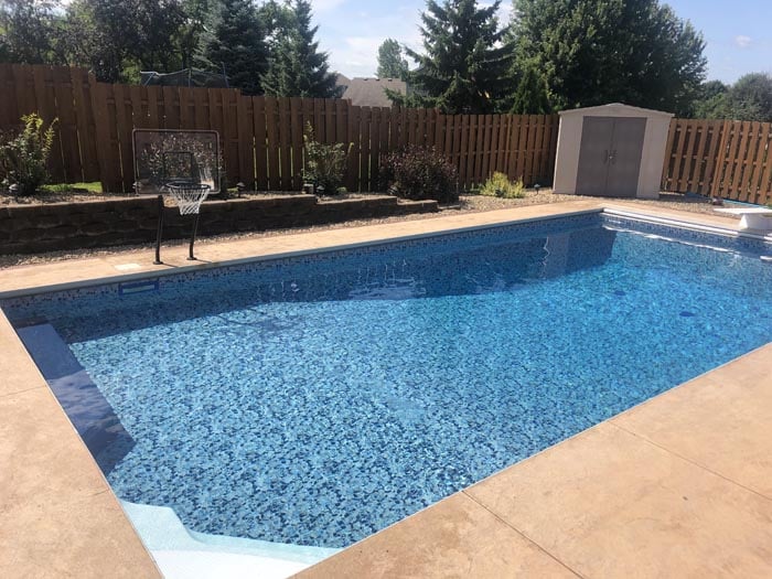 backyard pool with basketball.