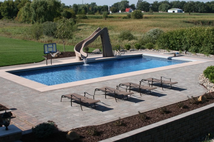 backyard pool with basketball and slide.