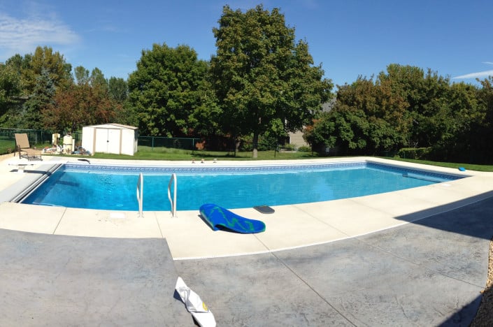 pool with shed in backyard.
