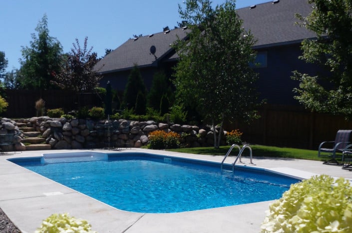 nicely landscaped backyard and pool.