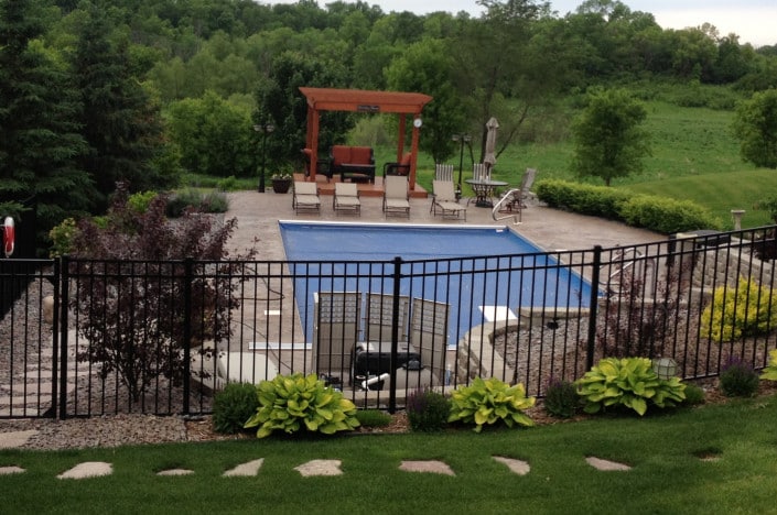 Backyard pool with fence.