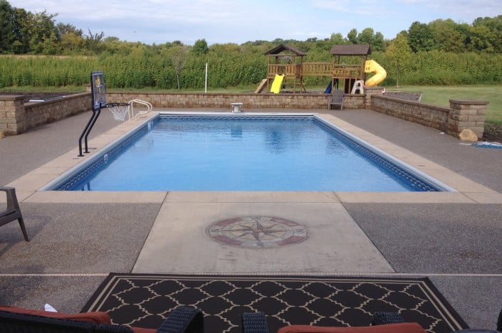 backyard pool with basketball and playset.