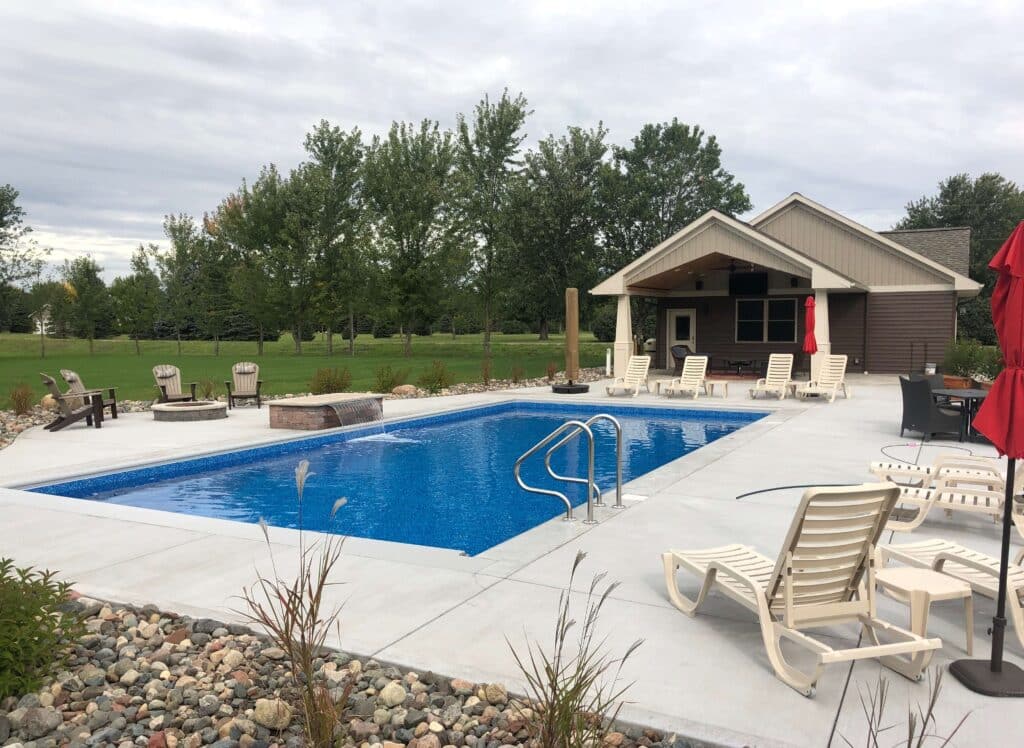 backyard with pool and pool house.