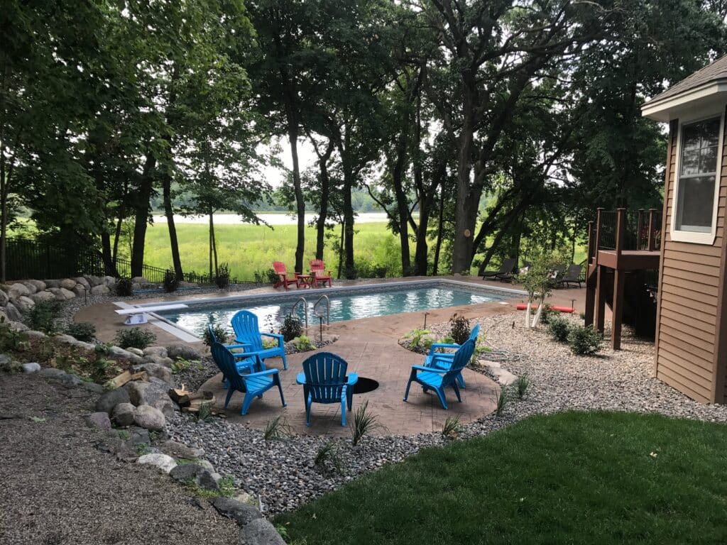 backyard pool with seating area.