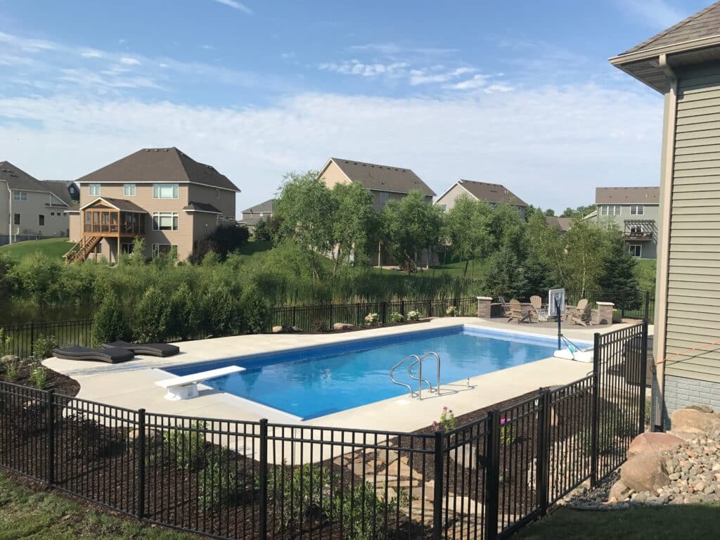 backyard pool with fence.
