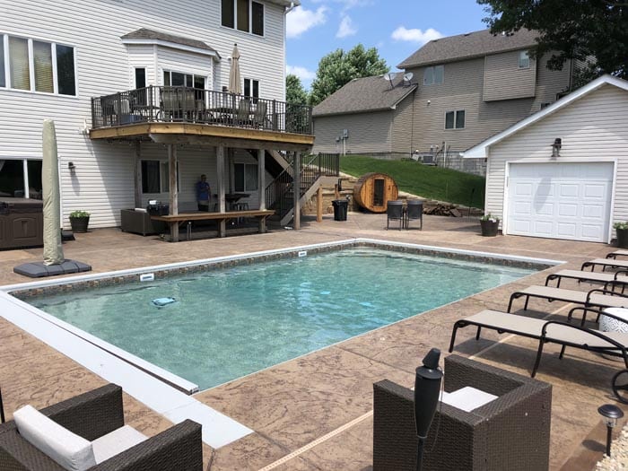backyard pool with deck and sauna.