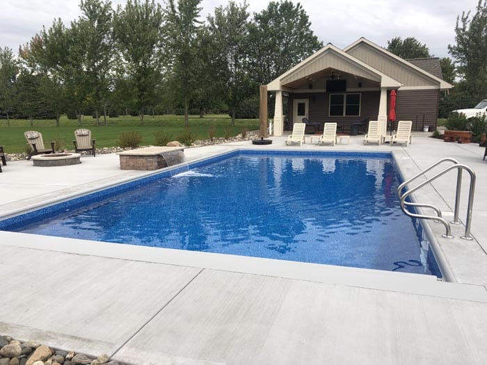 backyard pool with pool house.