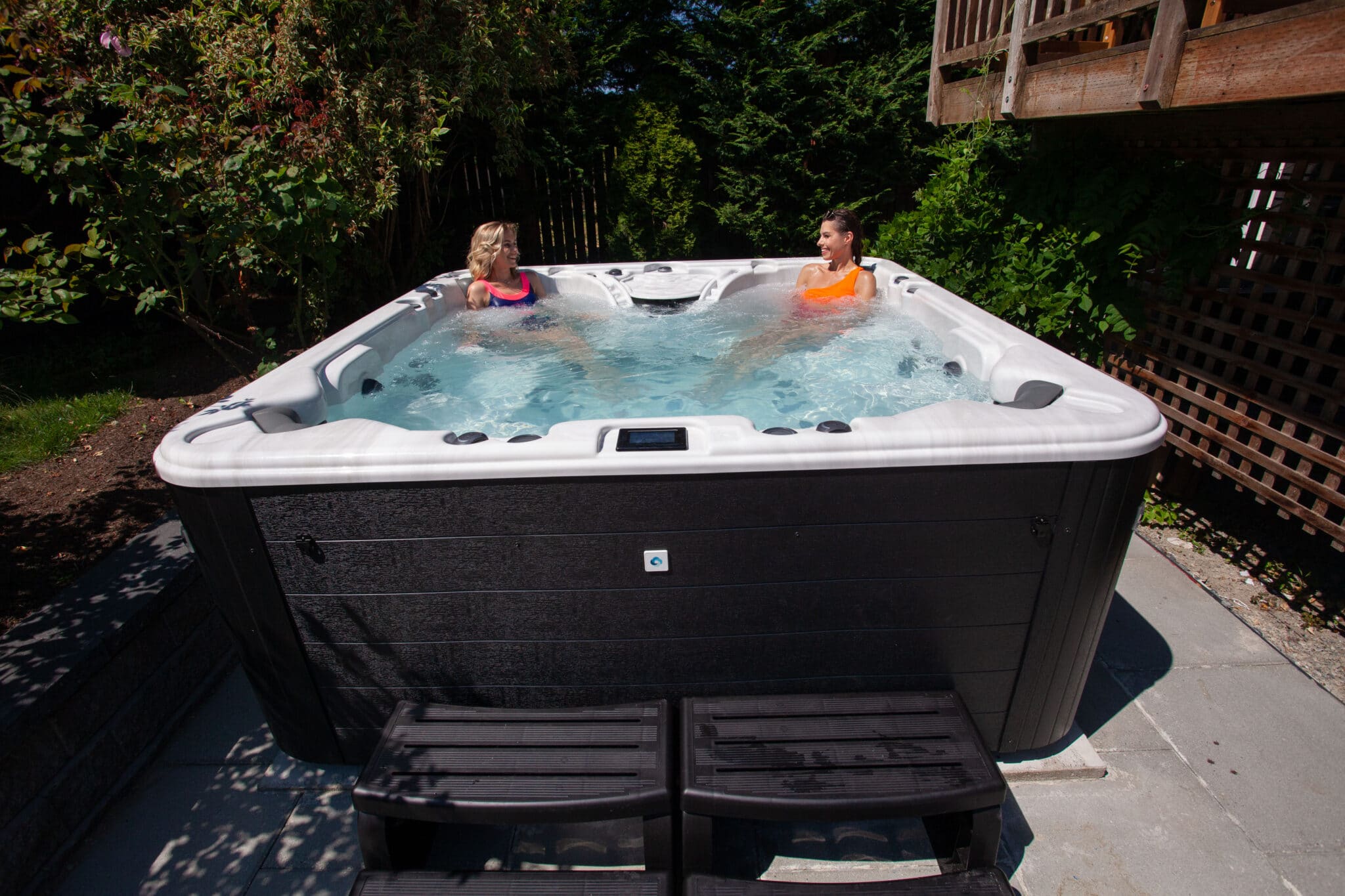 Two females in hot tub.